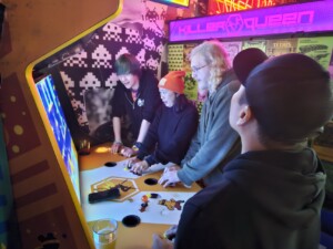 People playing on an 5v5 player arcade cabinet called "Killer Queen" at UpDown.